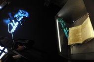 A man looks at the document of Gallileo Gallilei's trial proceedings during an opening of "Lux in Arcana , the Vatican Secret Archives reveals itself", at Musei Capitolini in Rome. Vatican archives documenting centuries of European history went on public display for the first time Wednesday. (AFP Photo/Tiziana Fabi)