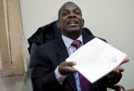 Investigative Magistrate Carves Jean holds out the case report of former dictator Jean-Claude "Baby Doc" Duvalier as he talks with reporters in his office in Port-au-Prince, Haiti, Monday Jan. 30, 2012. The Haitian judge said Monday that Duvalier should face trial for corruption, but not the more serious charges of human rights violations committed during his rule. Jean said the statute of limitations had run out on the human rights charges but not on the accusations of misappropriation of public funds. (AP Photo/Ramon Espinosa)