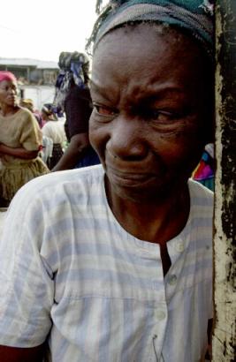 Janine Gilles looks at the remains of her rice stand which was destroyed yesterday when a massive arson fire consumed the old Gare du Nord marketplace in ... - haitian_merchants_15